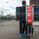 Illustration for article titled This Apocalypse-Ready Solar Charging Station Folds Up Behind a Bike